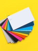 Color palette of paints on a yellow background. Top view, flat lay. Banner.